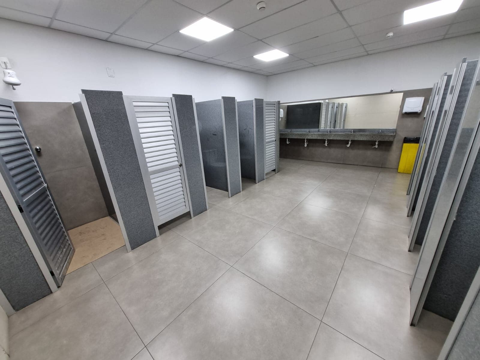 Vestiário reformado pela Construbello em fábrica da Denso, com divisórias modernas e banco central